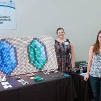 A student posing in front of her LED signage project